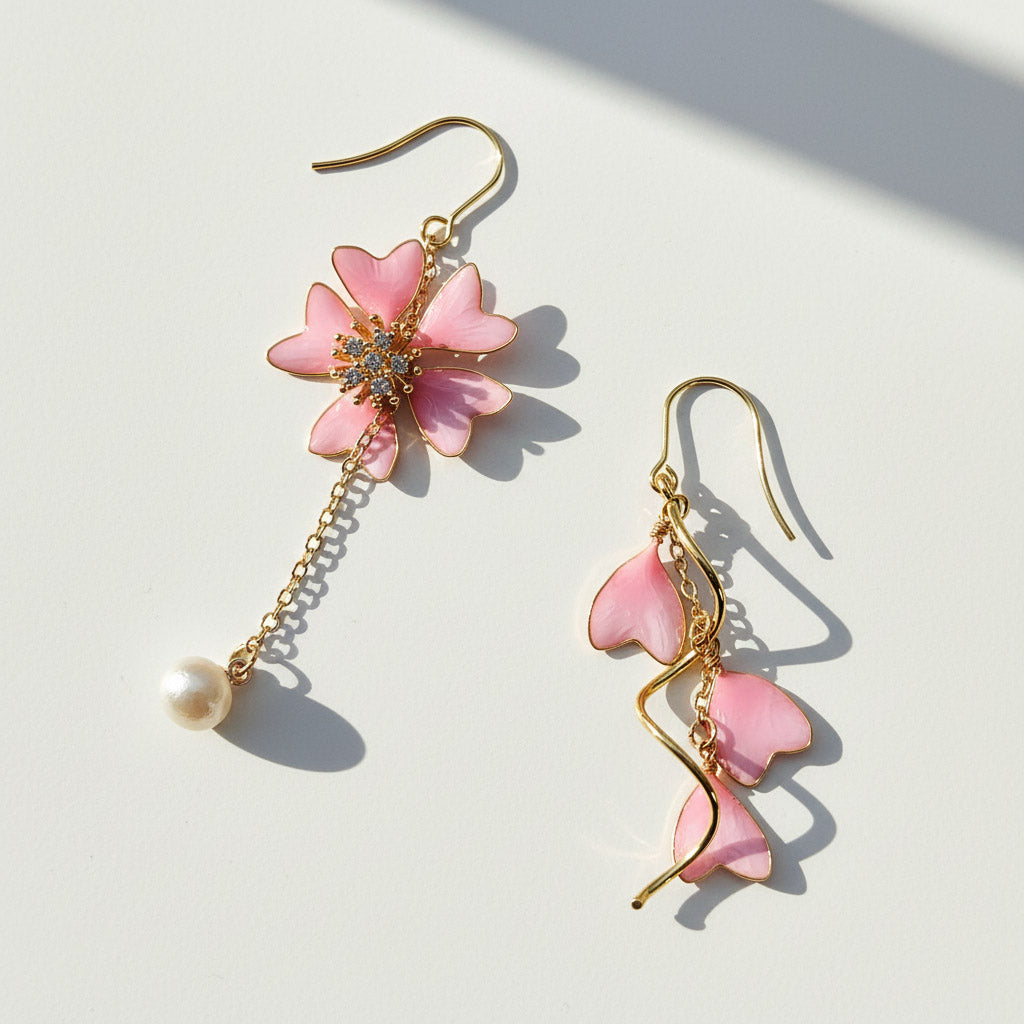 Pink flower-shaped earrings with gold hooks on a light background
