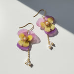 Floral earrings with pink and yellow flowers on a light background