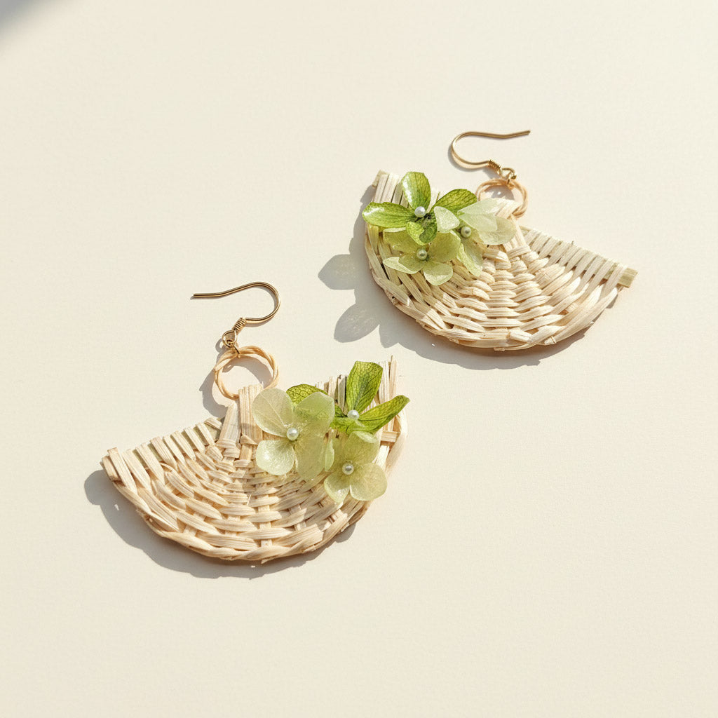 Wicker earrings with floral details on a beige background