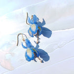 Handpainted blue iris flower earrings with green resin petals, pearl center, freshwater pearl drop, and gold-plated stainless steel hooks 