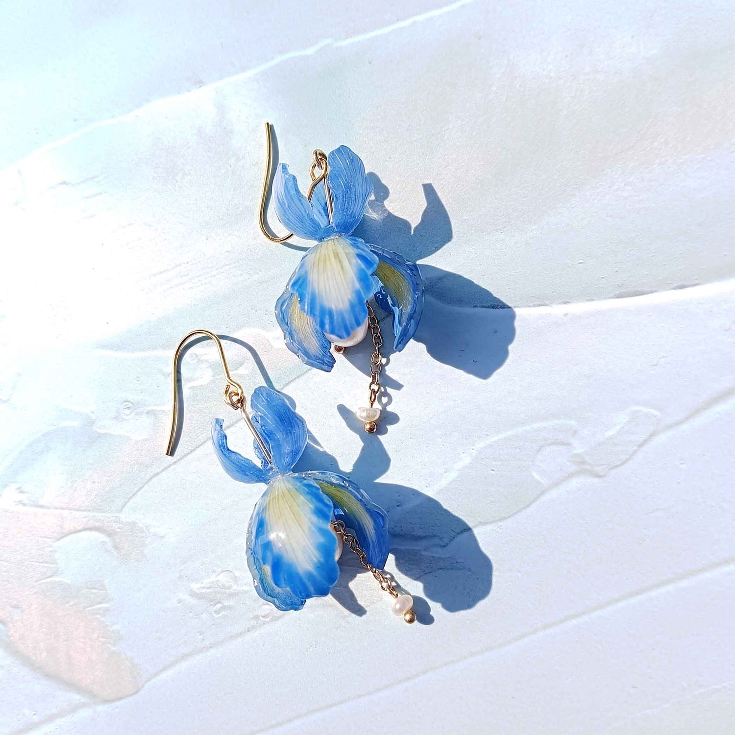 Handpainted blue iris flower earrings with green resin petals, pearl center, freshwater pearl drop, and gold-plated stainless steel hooks 