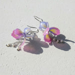 Pastel-colored butterfly-shaped earrings on a light background