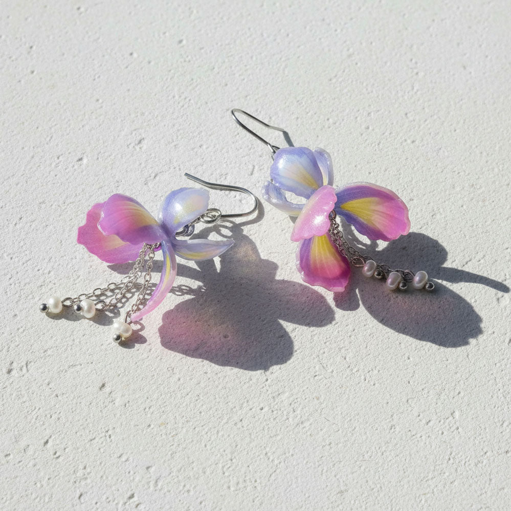 Pastel-colored butterfly-shaped earrings on a light background