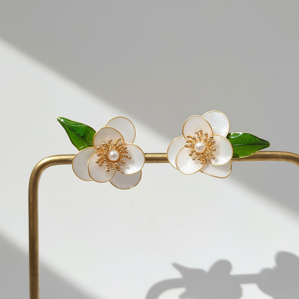 Floral headband with white flowers and gold accents on a light gray background