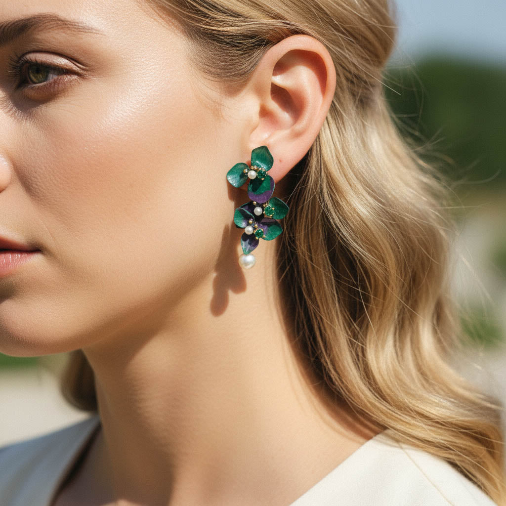 Close-up of a woman wearing green floral earrings with a blurred background