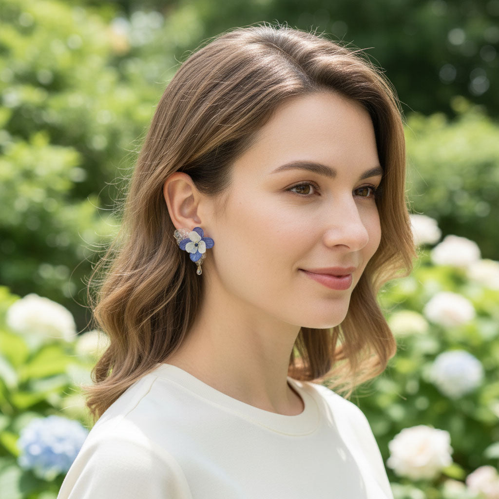 Woman wearing floral earrings with a blurred natural background
