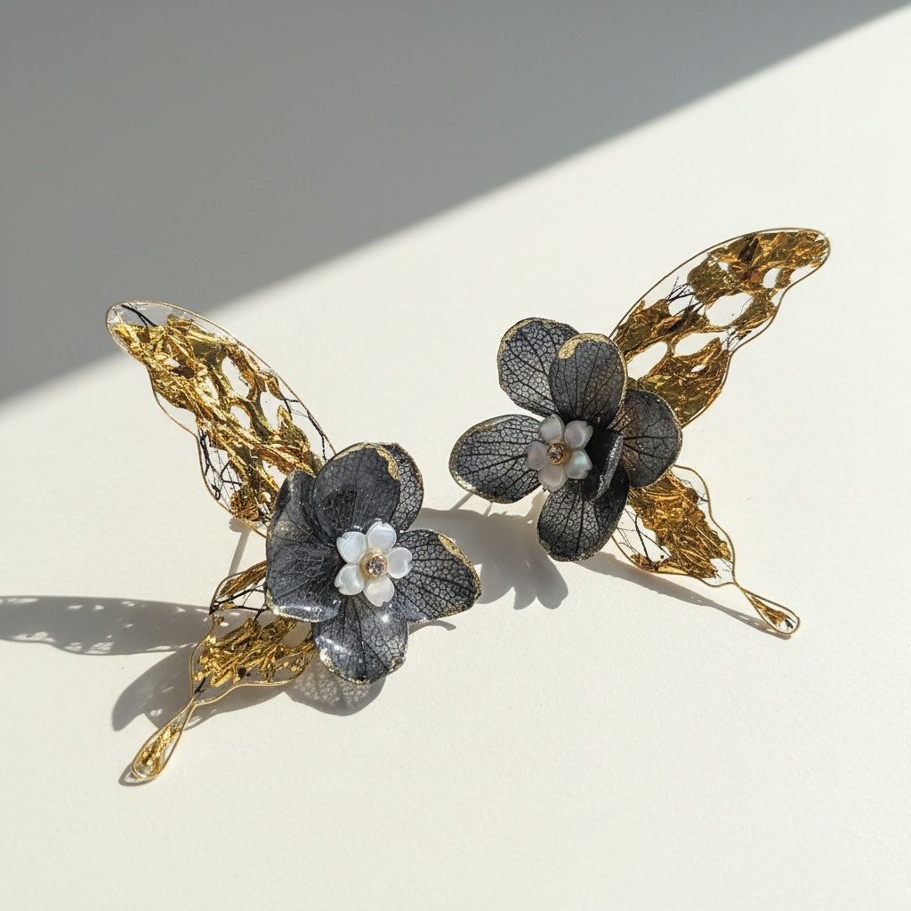 Butterfly and flower earrings on a light background