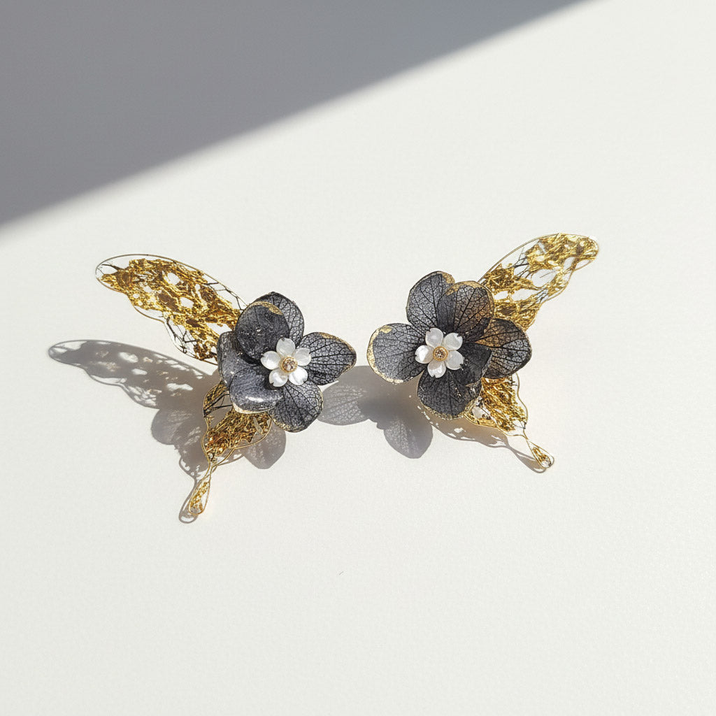 Pair of floral hair clips with gold accents on a light background