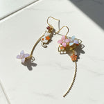 Floral earrings with gold accents on a light background