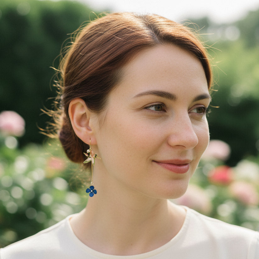 Woman wearing earrings with a blurred garden background