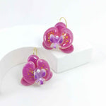 Handcrafted pink orchid enamel earrings with gold hooks and pearl center
