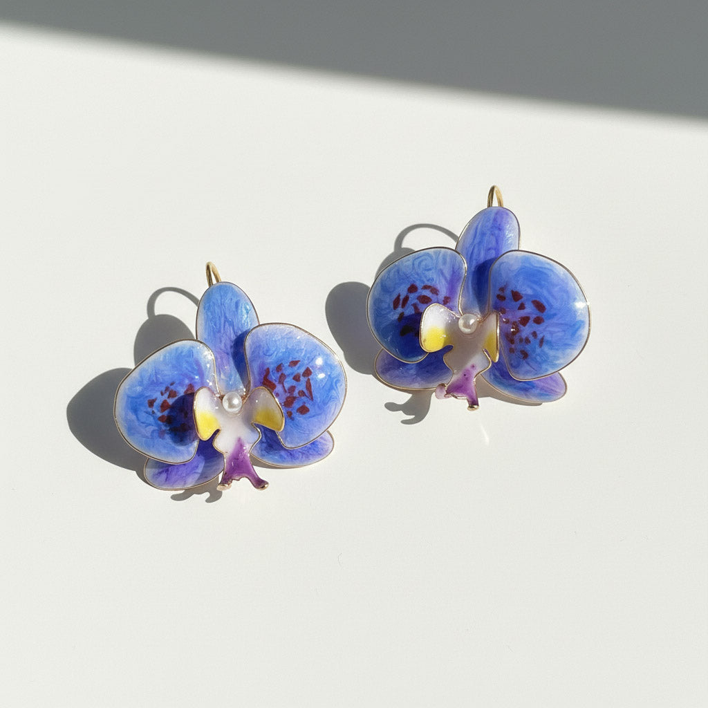 Blue orchid-shaped earrings on a light background