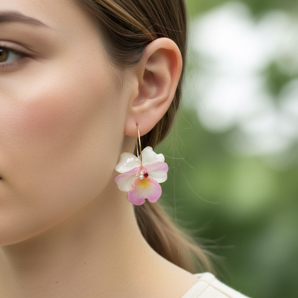 Close-up of a woman wearing a floral earring with a blurred natural background