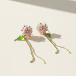 Floral earrings with chain details on a light background