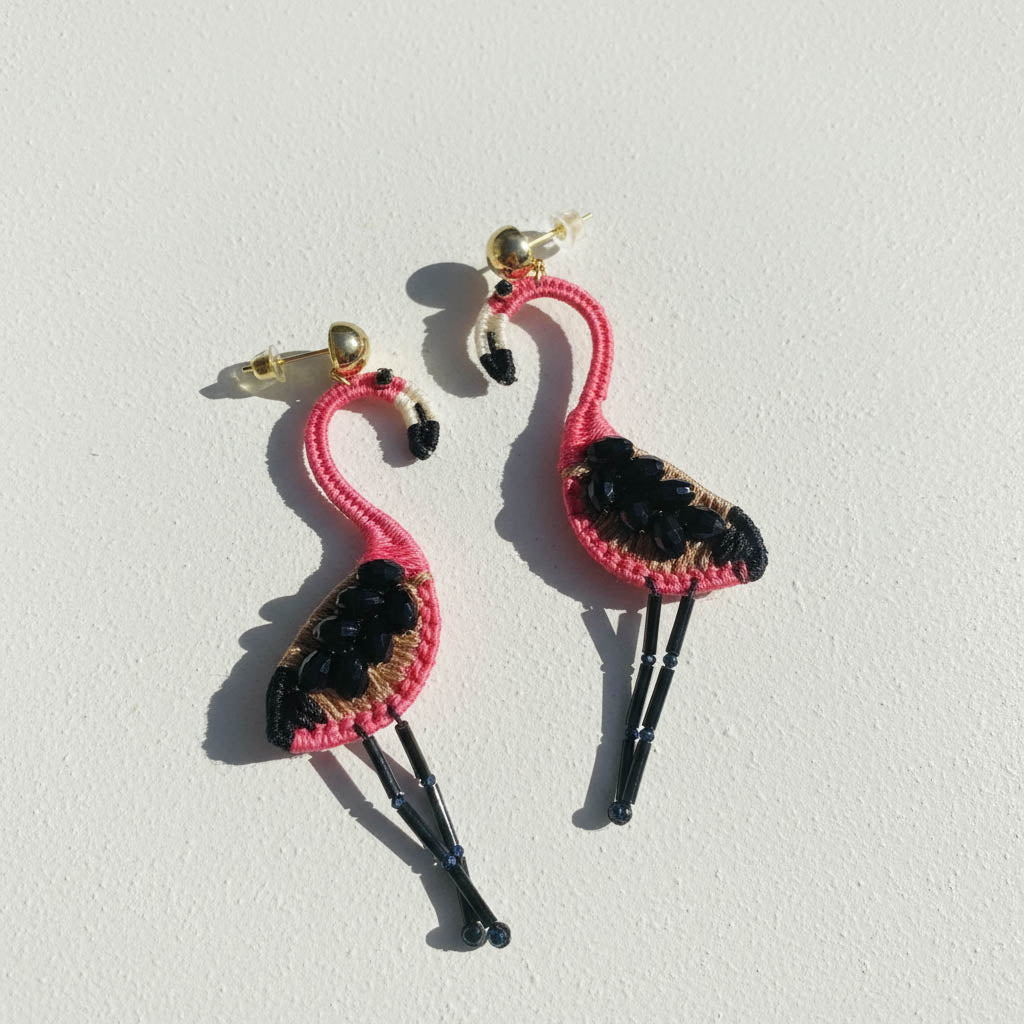 Flamingo-shaped earrings on a white background