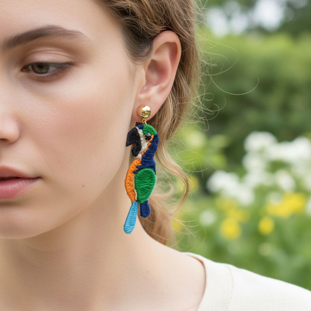 Close-up of a person wearing colorful earrings with a blurred natural background
