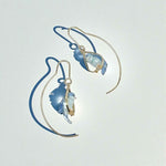 Pair of gold and blue earrings on a light gray background