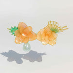 Decorative headband with floral design on a light gray background