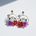 Earrings with ghost and bird design on a white background