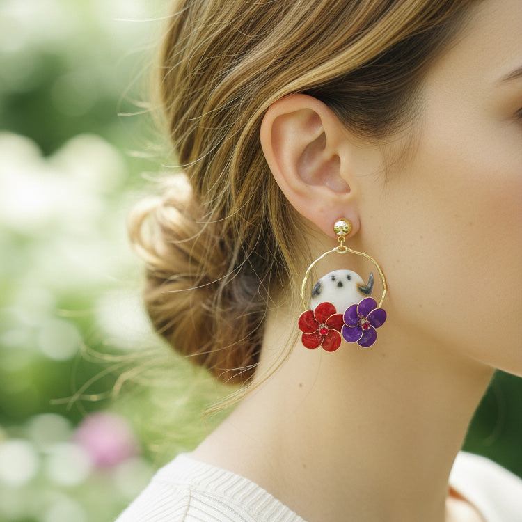Close-up of a person wearing a floral earring with a blurred natural background
