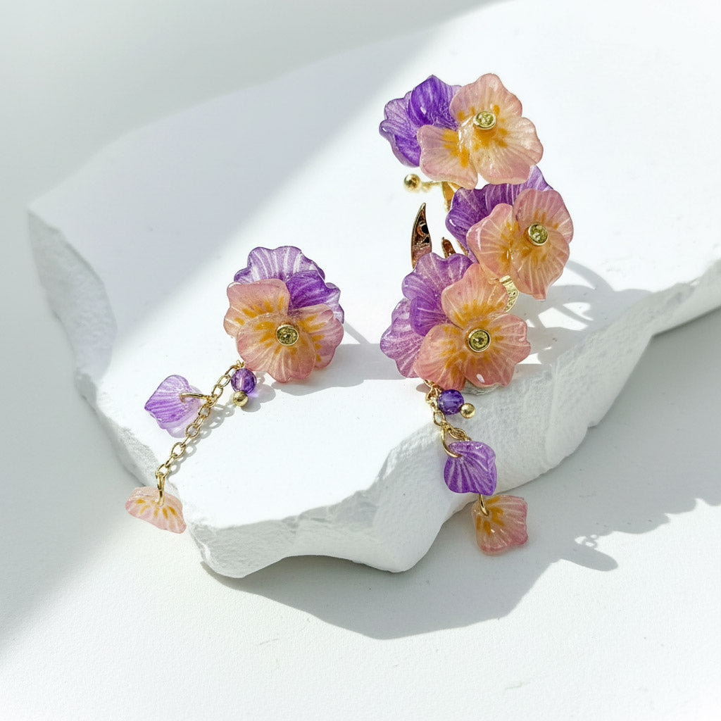 Colorful floral earrings on a white surface