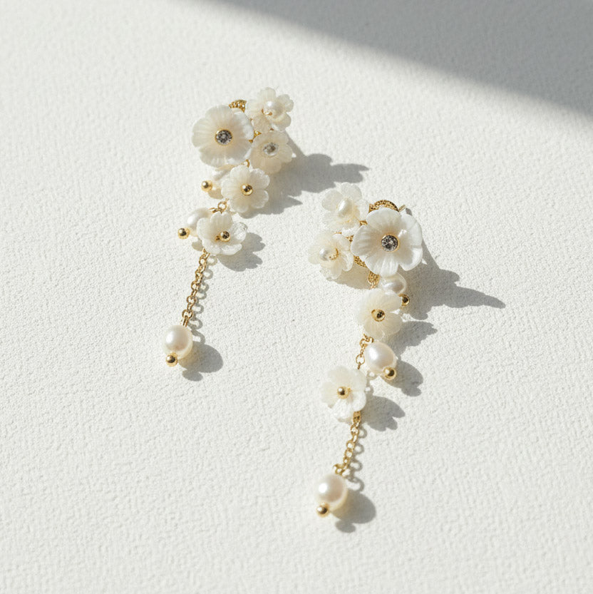 Floral pearl drop earrings with resin flowers and gold-plated accents.