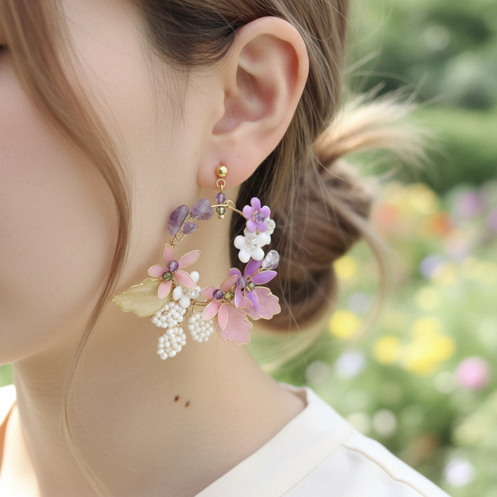 Close-up of a person wearing floral earrings with a blurred floral background