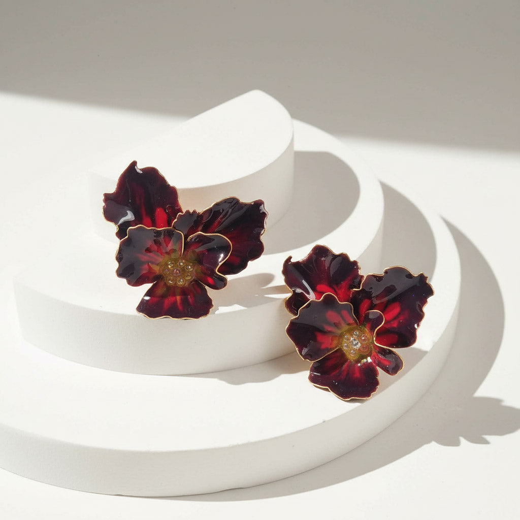 Floral earrings on a white surface with a soft shadow