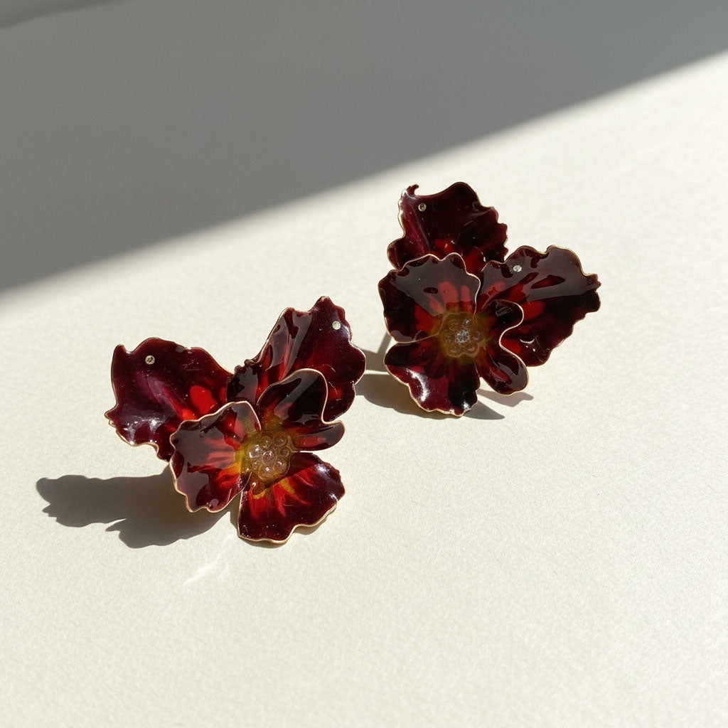 Pair of red floral earrings on a light background