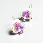 orchid earrings with purple and white flowers on a light gray background
