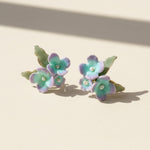 Pair of floral earrings on a beige background