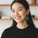 Woman wearing a black top with a blurred indoor background