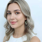 Woman with blonde hair and a white top against a light blue background
