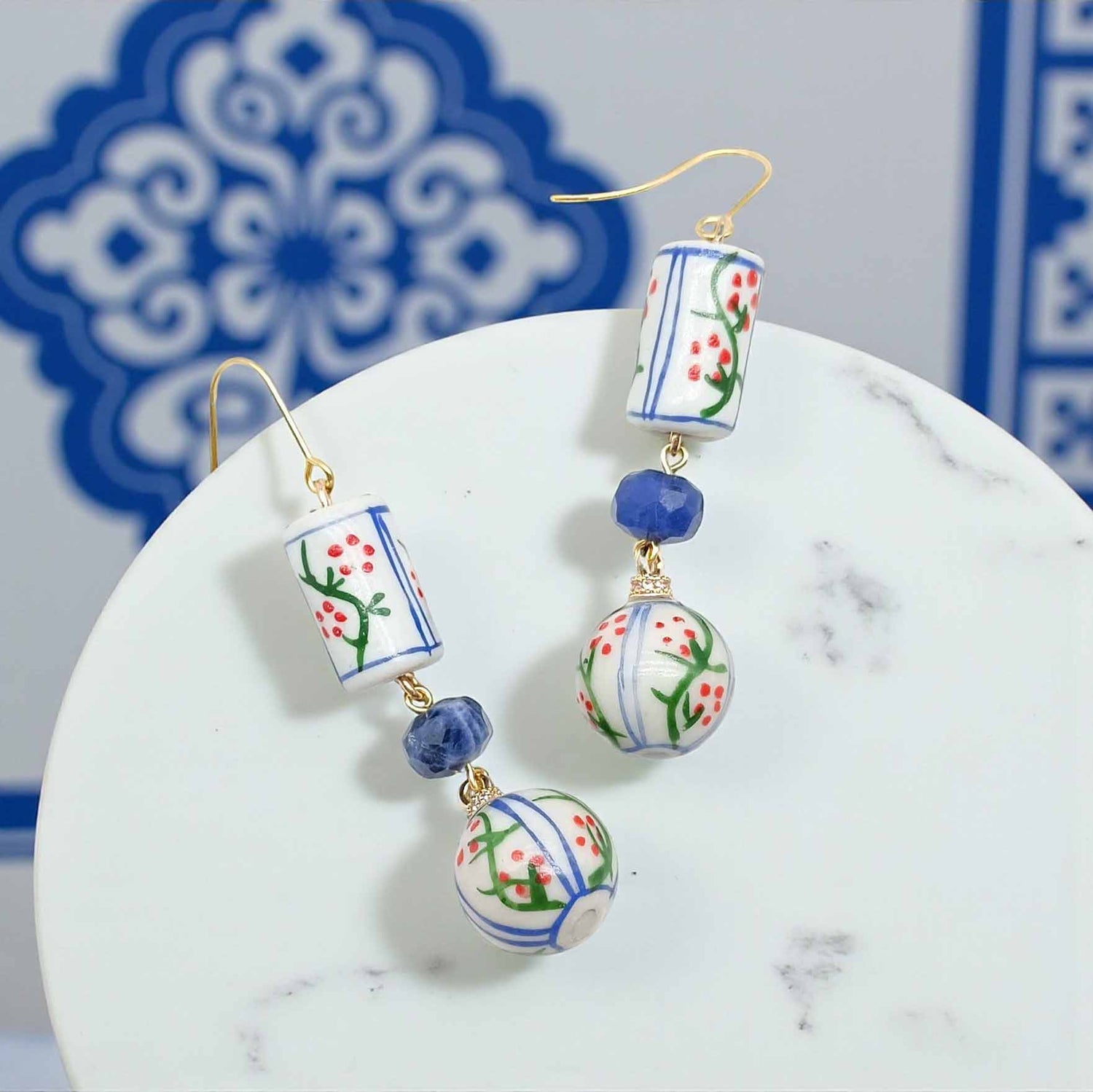 Decorative earrings with floral patterns on a white surface