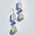 Decorative earrings with floral patterns on a light gray background