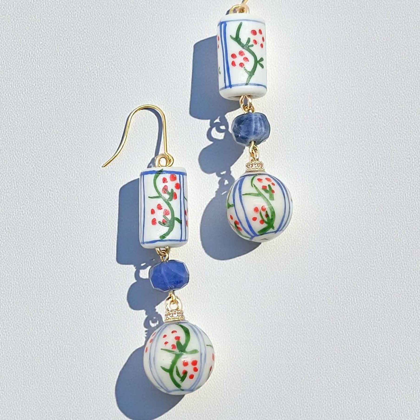 Decorative earrings with floral patterns on a light gray background