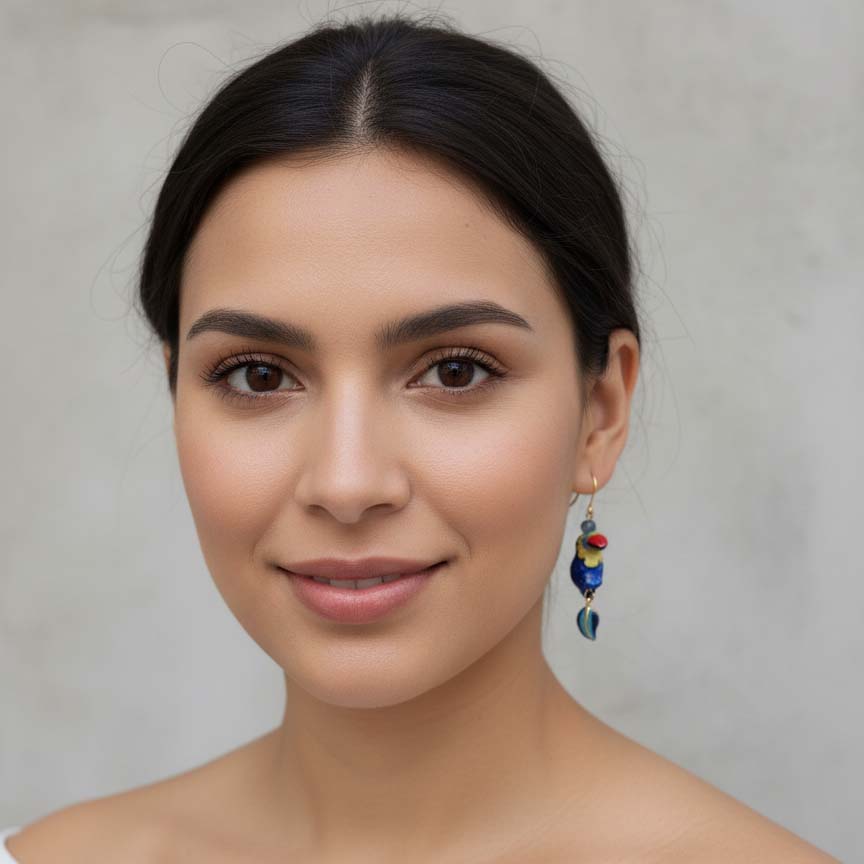 Woman wearing colorful earrings against a neutral background
