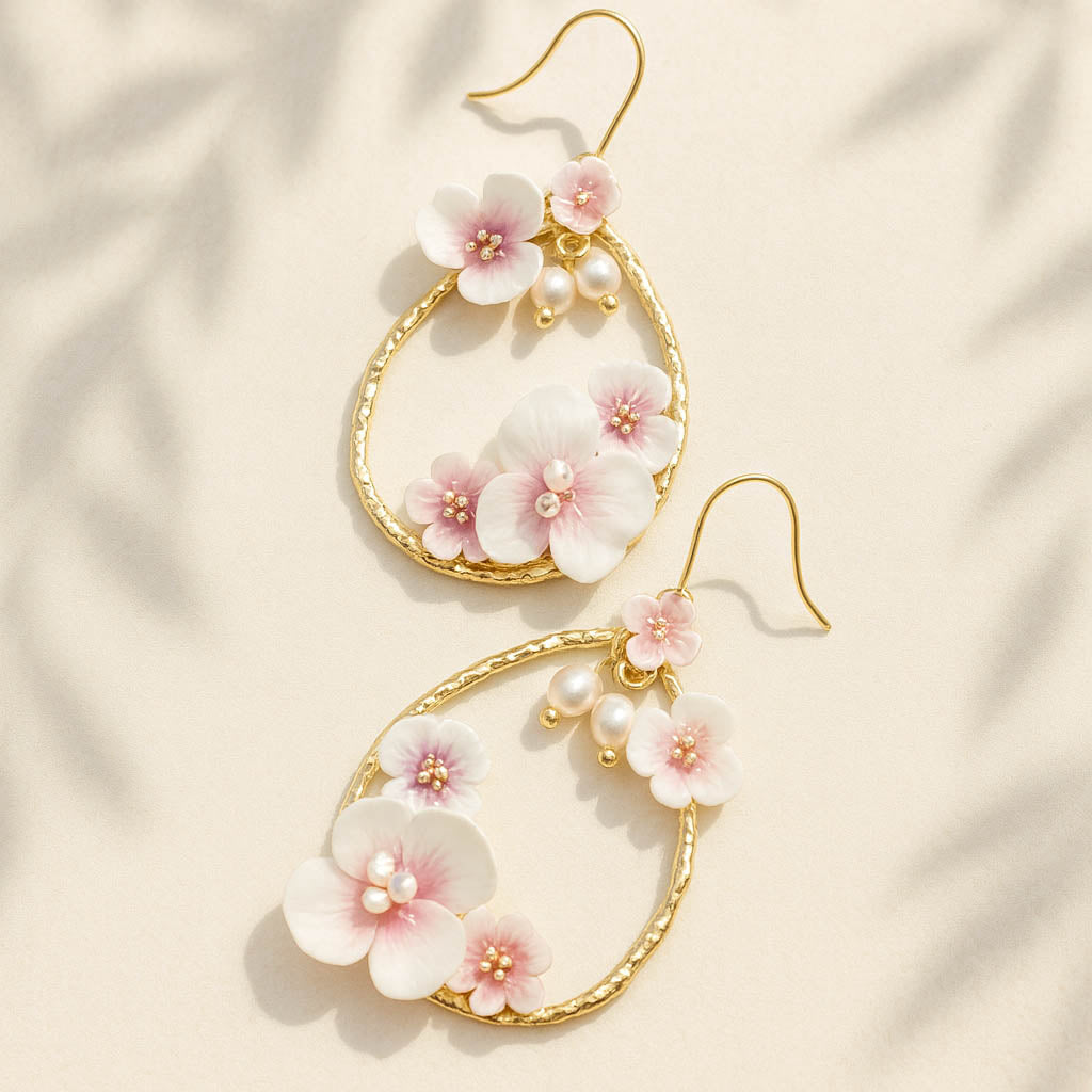 Floral earrings with gold hooks on a beige fabric background