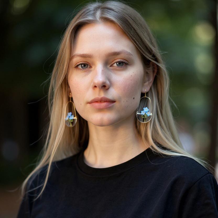 Woman wearing earrings with a blurred natural background