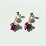 Purple enamel grape earrings with CZ and pearl detail on white background.