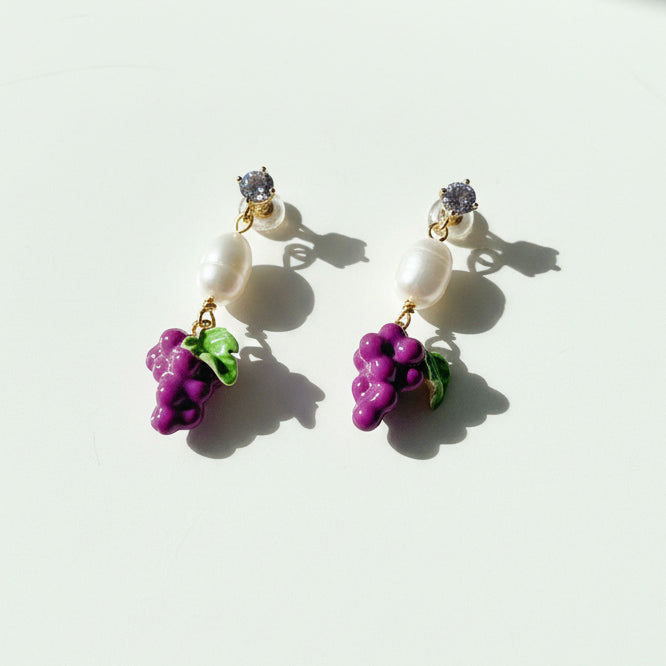 Purple enamel grape earrings with CZ and pearl detail on white background.