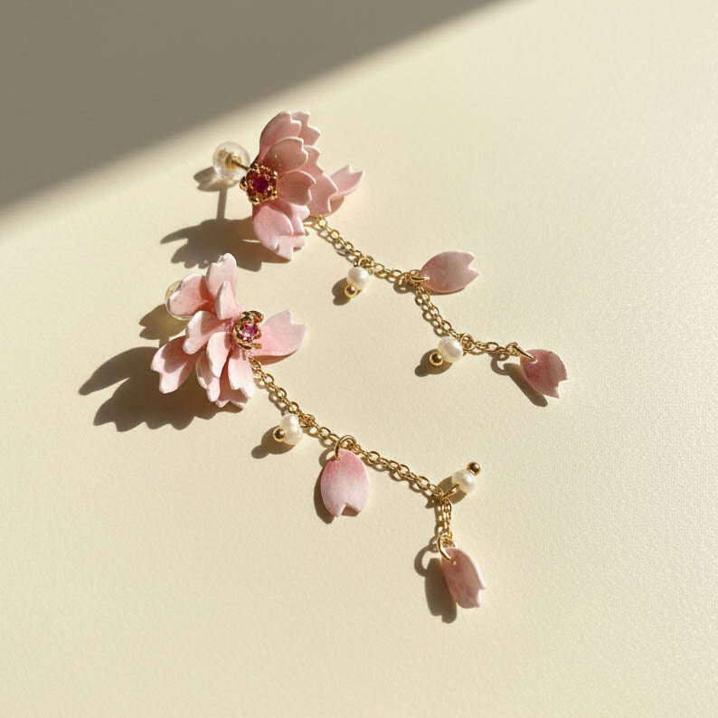 Delicate bracelet with pink floral charms on a light background
