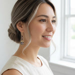 Model wearing cloisonné floral drop earrings