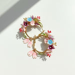 Decorative wreath with colorful flowers on a white background