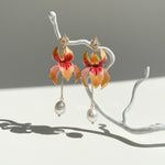 Coral and apricot enamel floral earrings with freshwater pearls.