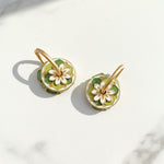 Reverse side showing enamel floral detailing in green and gold