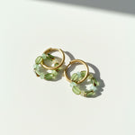 Green glass-bead hoops in sunlight