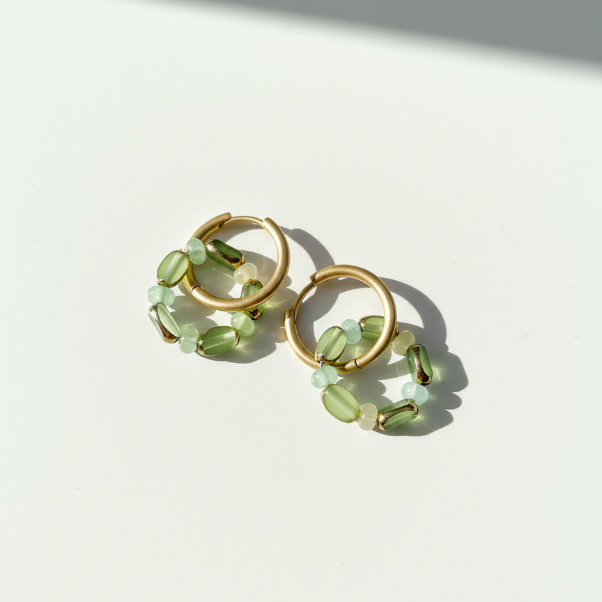 Green glass-bead hoops in sunlight