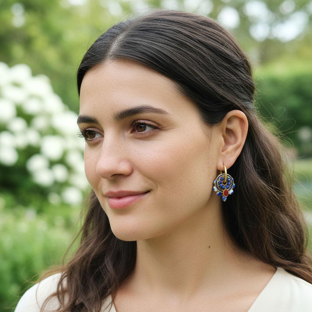 Woman wearing earrings with a blurred green background