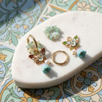 Convertible earring set on a decorative stone surface